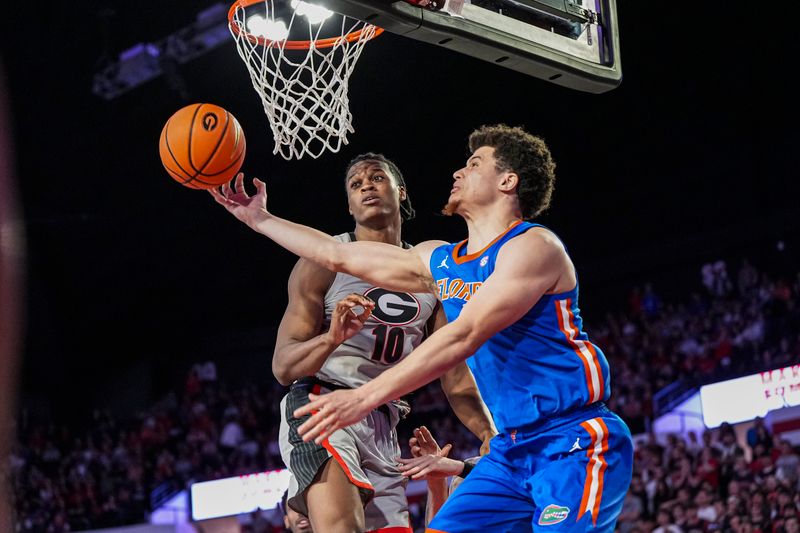 Feb 25, 2025; Athens, Georgia, USA; Florida Gators guard Walter Clayton Jr. (1) shoots under the basket behind Georgia Bulldogs forward RJ Godfrey (10) during the second half at Stegeman Coliseum. Mandatory Credit: Dale Zanine-Imagn Images