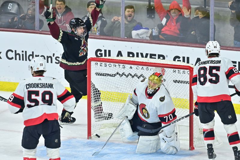 Dec 19, 2023; Tempe, Arizona, USA; Ottawa Senators goaltender Joonas Korpisalo (70) gives up a gaol to Arizona Coyotes right wing Clayton Keller (not pictured) as defenseman Juuso Valimaki (4) celebrates in the third period at Mullett Arena. Mandatory Credit: Matt Kartozian-USA TODAY Sports