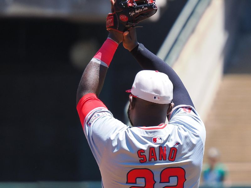 Jul 4, 2024; Oakland, California, USA; Los Angeles Angels third baseman Miguel Sano (22) claps after center fielder Kevin Pillar (not pictured) made a play above the wall against the Oakland Athletics during the first inning at Oakland-Alameda County Coliseum. Mandatory Credit: Kelley L Cox-USA TODAY Sports