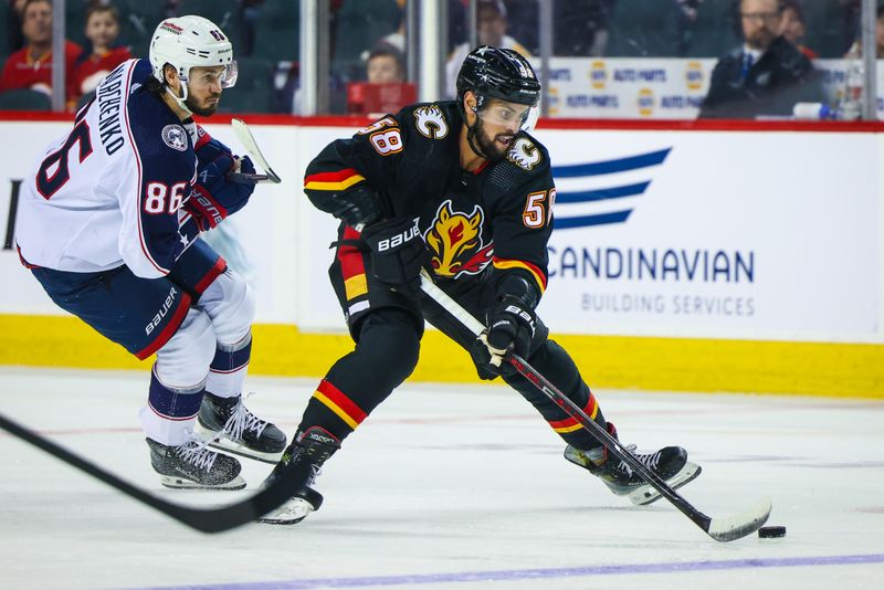 Jan 25, 2024; Calgary, Alberta, CAN; Calgary Flames defenseman Oliver Kylington (58) controls the puck against the Columbus Blue Jackets during the third period at Scotiabank Saddledome. Mandatory Credit: Sergei Belski-USA TODAY Sports