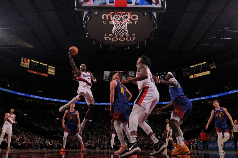 PORTLAND, OR - FEBRUARY 23: Duop Reath #26 of the Portland Trail Blazers drives to the basket during the game against the Denver Nuggets on February 23, 2024 at the Moda Center Arena in Portland, Oregon. NOTE TO USER: User expressly acknowledges and agrees that, by downloading and or using this photograph, user is consenting to the terms and conditions of the Getty Images License Agreement. Mandatory Copyright Notice: Copyright 2024 NBAE (Photo by Cameron Browne/NBAE via Getty Images)