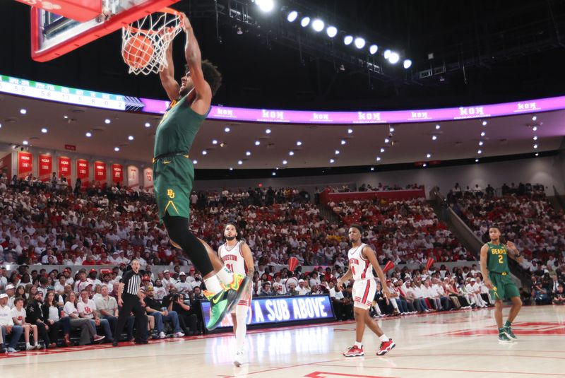 Feb 10, 2025; Houston, Texas, USA; Baylor Bears forward Norchad Omier (15) dunks against the Houston Cougars  in the first half at Fertitta Center. Mandatory Credit: Thomas Shea-Imagn Images