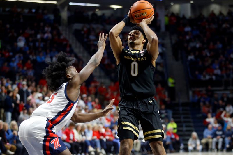 Jan 13, 2024; Oxford, Mississippi, USA; Vanderbilt Commodores guard Tyrin Lawrence (0) shoots the ball against Mississippi Rebels guard Jaylen Murray (5) during the first half at The Sandy and John Black Pavilion at Ole Miss. Mandatory Credit: Petre Thomas-USA TODAY Sports