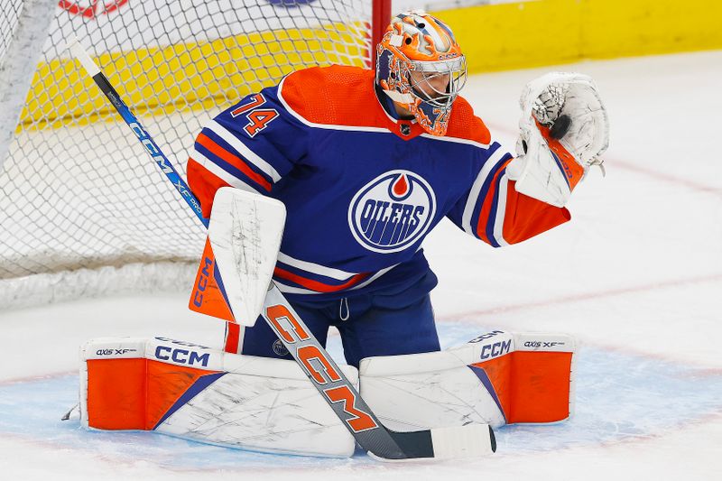 Oct 14, 2023; Edmonton, Alberta, CAN; Edmonton Oilers goaltender Stuart Skinner (74) makes a save during warmup against the Vancouver Canucks at Rogers Place. Mandatory Credit: Perry Nelson-USA TODAY Sports