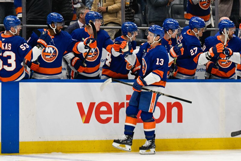 Jan 6, 2026; Elmont, New York, USA;  New York Islanders center Mathew Barzal (13) celebrates his goal against the New Jersey Devils during the first period at UBS Arena. Mandatory Credit: Dennis Schneidler-Imagn Images