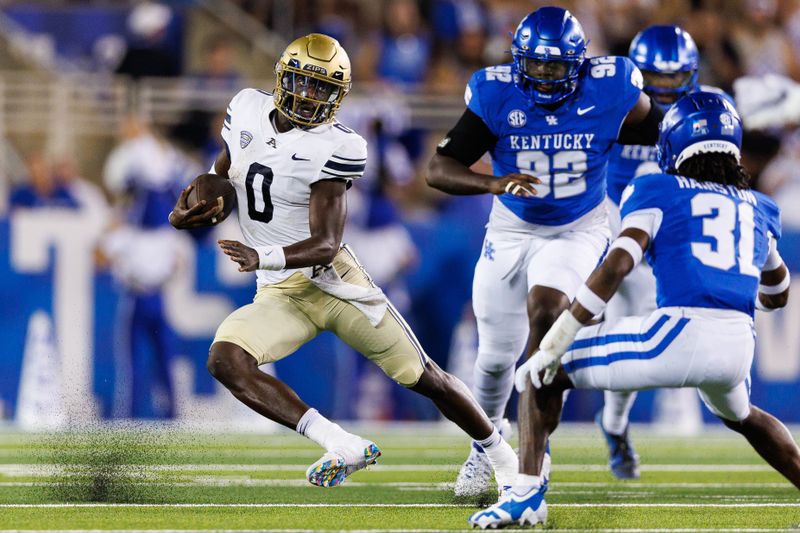 Sep 16, 2023; Lexington, Kentucky, USA; Akron Zips quarterback DJ Irons (0) carries the ball during the first quarter against the Kentucky Wildcats at Kroger Field. Mandatory Credit: Jordan Prather-USA TODAY Sports