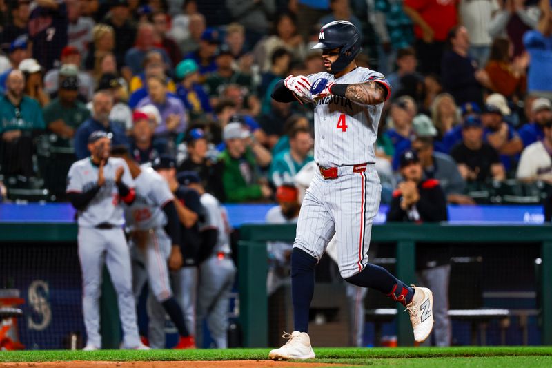 May 30, 2025; Seattle, Washington, USA; Minnesota Twins shortstop Carlos Correa (4) celebrates after hitting a two-run home run against the Seattle Mariners during the tenth inning at T-Mobile Park. Mandatory Credit: Joe Nicholson-Imagn Images