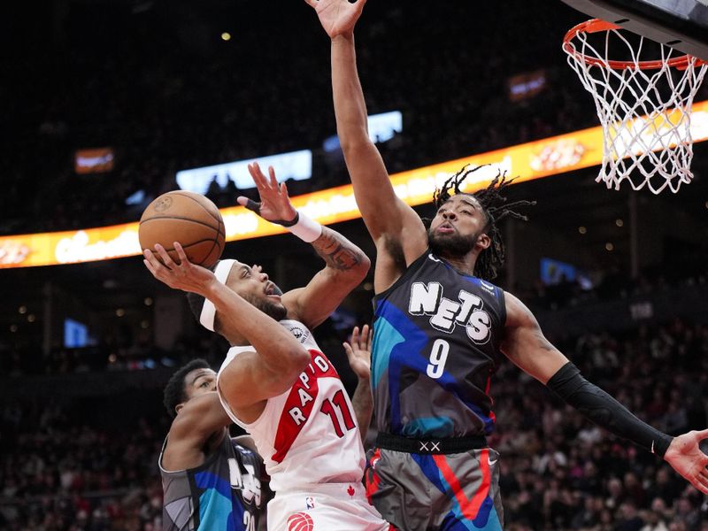 TORONTO, ON - MARCH 25: Bruce Brown #11 of the Toronto Raptors shoots against Trendon Watford #9 of the Brooklyn Nets during the second half at the Scotiabank Arena on March 25, 2024 in Toronto, Ontario, Canada. NOTE TO USER: User expressly acknowledges and agrees that, by downloading and/or using this Photograph, user is consenting to the terms and conditions of the Getty Images License Agreement. (Photo by Mark Blinch/Getty Images)