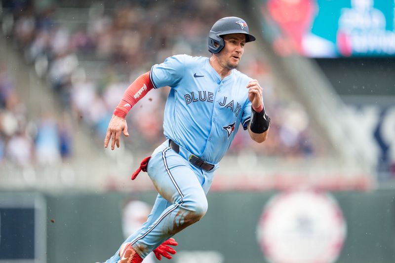 Jun 7, 2025; Minneapolis, Minnesota, USA; Toronto Blue Jays catcher Tyler Heineman (55) runs to home plate to score on a hit by first base Vladimir Guerrero Jr. (27) off a pitch by Minnesota Twins pitcher Jhoan Duran (59) in the ninth inning at Target Field. Mandatory Credit: Matt Blewett-Imagn Images