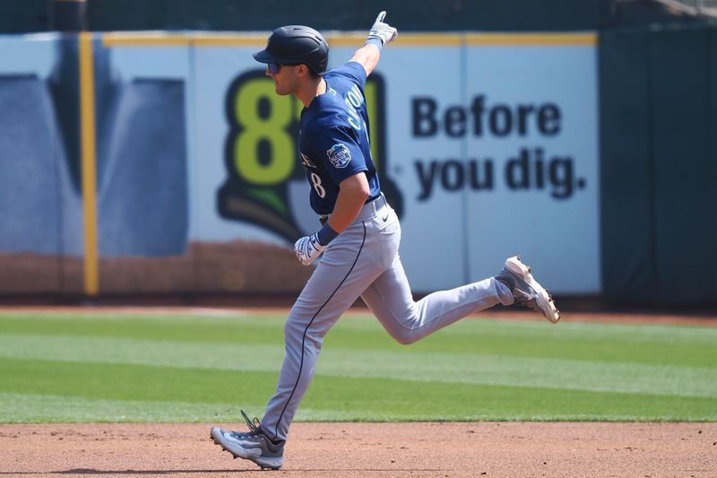 Sep 20, 2023; Oakland, California, USA; Seattle Mariners left fielder Dominic Canzone (8) gestures to teammates as he rounds the bases on a two-run home run against the Oakland Athletics during the second inning at Oakland-Alameda County Coliseum. Mandatory Credit: Kelley L Cox-USA TODAY Sports
