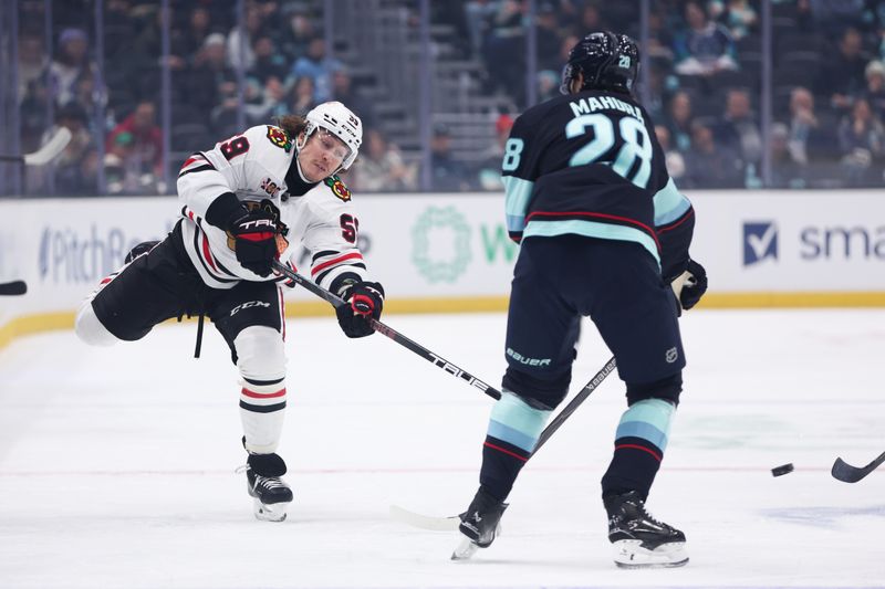 Nov 3, 2025; Seattle, Washington, USA; Chicago Blackhawks left wing Tyler Bertuzzi (59) passes the puck in the first period against the Seattle Kraken at Climate Pledge Arena. Mandatory Credit: Kevin Ng-Imagn Images
