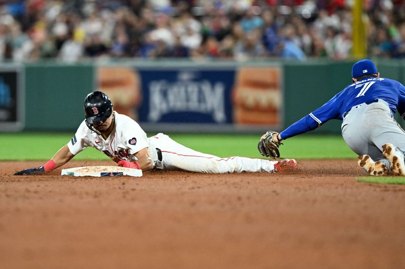 Aug 27, 2024; Boston, Massachusetts, USA; Boston Red Sox shortstop David Hamilton (70) steals second base against Toronto Blue Jays third baseman Will Wagner (7) during the fifth inning at Fenway Park. Mandatory Credit: Brian Fluharty-USA TODAY Sports