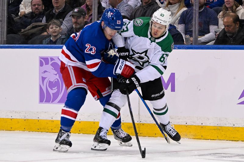 Jan 7, 2025; New York, New York, USA;  New York Rangers defenseman Adam Fox (23) defends against Dallas Stars right wing Evgenii Dadonov (63) during the second period at Madison Square Garden. Mandatory Credit: Dennis Schneidler-Imagn Images