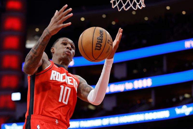 HOUSTON, TEXAS - NOVEMBER 06: Jabari Smith Jr. #10 of the Houston Rockets grabs a rebound against the Sacramento Kings during the first half at Toyota Center on November 06, 2023 in Houston, Texas. (Photo by Carmen Mandato/Getty Images)