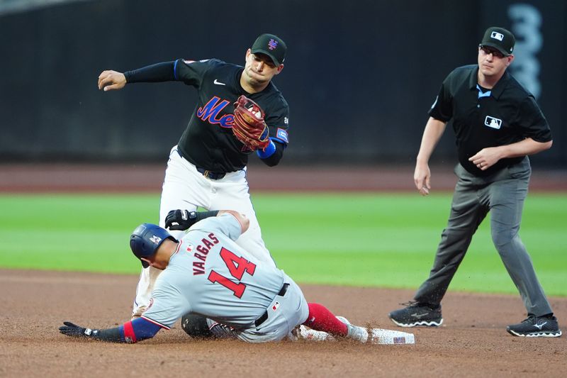 Jul 10, 2024; New York City, New York, USA; Washington Nationals third baseman Ildemaro Vargas (14) steals second base with New York Mets second baseman Jose Iglesias (11) receiving the throw during the fourth inning at Citi Field. Mandatory Credit: Gregory Fisher-USA TODAY Sports