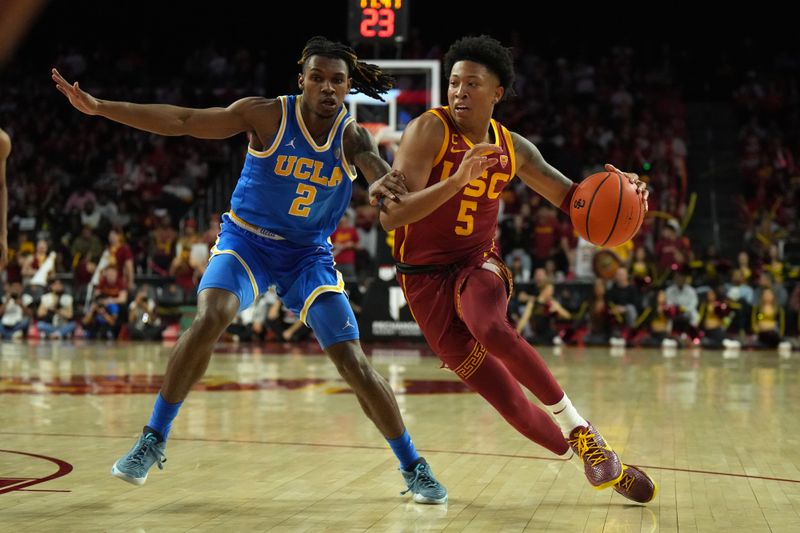 Jan 27, 2024; Los Angeles, California, USA; Southern California Trojans guard Boogie Ellis (5) dribbles the ball against UCLA Bruins guard Dylan Andrews (2) in the second half at Galen Center. Mandatory Credit: Kirby Lee-USA TODAY Sports