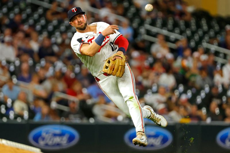 Sep 28, 2024; Minneapolis, Minnesota, USA; Minnesota Twins third baseman Kyle Farmer (12) throws to first during the fifth inning against the Baltimore Orioles at Target Field. Mandatory Credit: Bruce Kluckhohn-Imagn Images