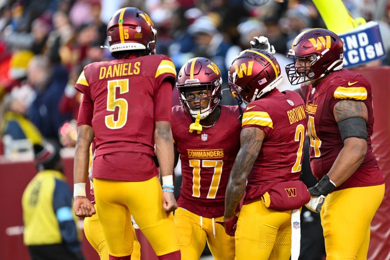 Washington Commanders wide receiver Terry McLaurin (17) celebrates his touchdown reception with teammates during the second half of an NFL football game against the Dallas Cowboys, Sunday, Nov. 24, 2024, in Landover, Md. (AP Photo/Terrance Williams)