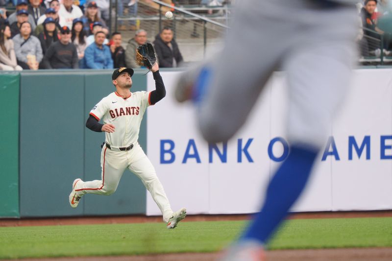 Apr 24, 2024; San Francisco, California, USA; San Francisco Giants left fielder Michael Conforto (8) catches the ball behind a New York Mets runner to end the top of the first inning at Oracle Park. Mandatory Credit: Kelley L Cox-USA TODAY Sports