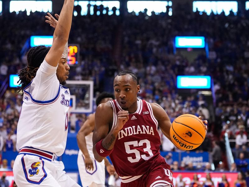 Dec 17, 2022; Lawrence, Kansas, USA; Indiana Hoosiers guard Tamar Bates (53) drives against Kansas Jayhawks guard Bobby Pettiford Jr. (0) during the first half at Allen Fieldhouse. Mandatory Credit: Jay Biggerstaff-USA TODAY Sports
