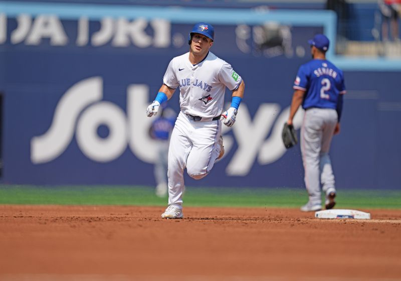 Jul 27, 2024; Toronto, Ontario, CAN; Toronto Blue Jays outfielder Daulton Varsho (25) runs the bases after hitting a three run home run against the Texas Rangers during the first inning at Rogers Centre. Mandatory Credit: Nick Turchiaro-USA TODAY Sports