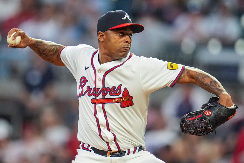 May 20, 2024; Cumberland, Georgia, USA; Atlanta Braves relief pitcher Raisel Iglesias (26) pitches against the San Diego Padres during the ninth inning at Truist Park.Mandatory Credit: Dale Zanine-USA TODAY Sports