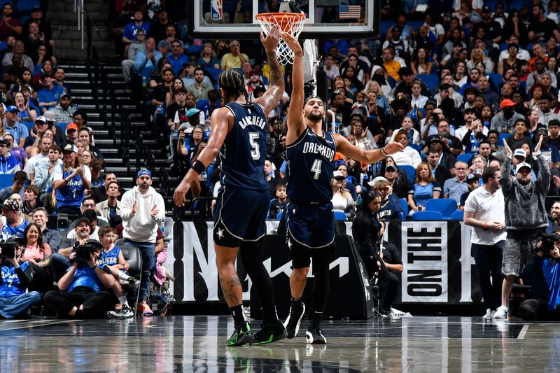 ORLANDO, FL - MARCH 21: Paolo Banchero #5 and Jalen Suggs #4 of the Orlando Magic high five during the game against the New Orleans Pelicans on March 21, 2024 at Amway Center in Orlando, Florida. NOTE TO USER: User expressly acknowledges and agrees that, by downloading and or using this photograph, User is consenting to the terms and conditions of the Getty Images License Agreement. Mandatory Copyright Notice: Copyright 2024 NBAE (Photo by Fernando Medina/NBAE via Getty Images)