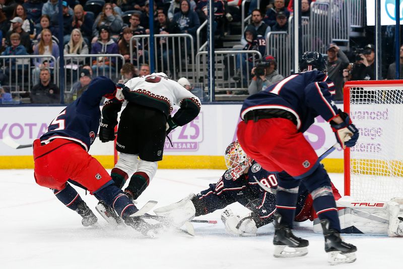 Nov 16, 2023; Columbus, Ohio, USA; Columbus Blue Jackets goalie Elvis Merzlikins (90) makes a save as Arizona Coyotes center Clayton Keller (9) looks for a rebound during the third period at Nationwide Arena. Mandatory Credit: Russell LaBounty-USA TODAY Sports