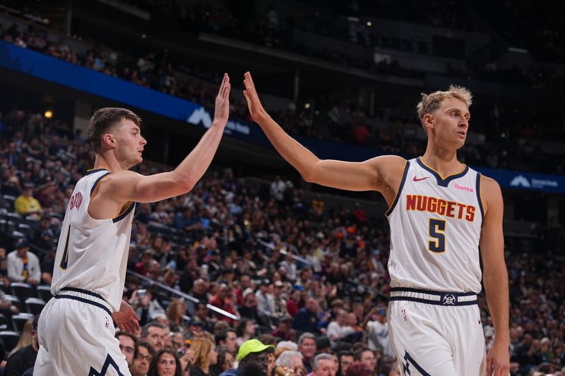 DENVER, CO - OCTOBER 13: Christian Braun #0 and Hunter Tyson #5 of the Denver Nuggets high five during the game against the Phoenix Suns on October 13, 2024 at Ball Arena in Denver, Colorado. NOTE TO USER: User expressly acknowledges and agrees that, by downloading and/or using this Photograph, user is consenting to the terms and conditions of the Getty Images License Agreement. Mandatory Copyright Notice: Copyright 2024 NBAE (Photo by Bart Young/NBAE via Getty Images)