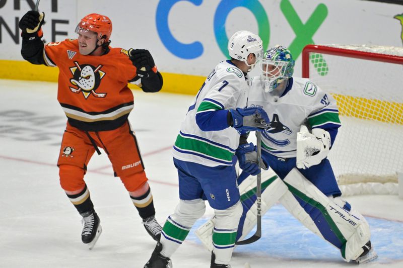 Nov 5, 2024; Anaheim, California, USA; Vancouver Canucks defenseman Carson Soucy (7) and goaltender Kevin Lankinen (32) look on as Anaheim Ducks center Mason McTavish (23) celebrates after a goal in the first period at Honda Center. Mandatory Credit: Jayne Kamin-Oncea-Imagn Images