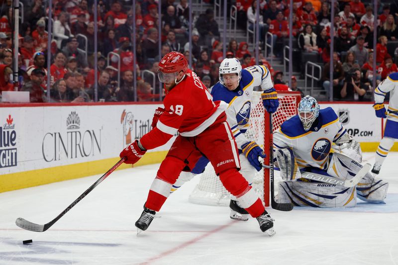 Apr 7, 2024; Detroit, Michigan, USA; Detroit Red Wings center Andrew Copp (18) skates with the puck chased by Buffalo Sabres defenseman Henri Jokiharju (10) in the second period at Little Caesars Arena. Mandatory Credit: Rick Osentoski-USA TODAY Sports