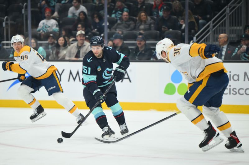 Jan 1, 2026; Seattle, Washington, USA; Seattle Kraken center Shane Wright (51) passes the puck against the Nashville Predators during the first period at Climate Pledge Arena. Mandatory Credit: Steven Bisig-Imagn Images