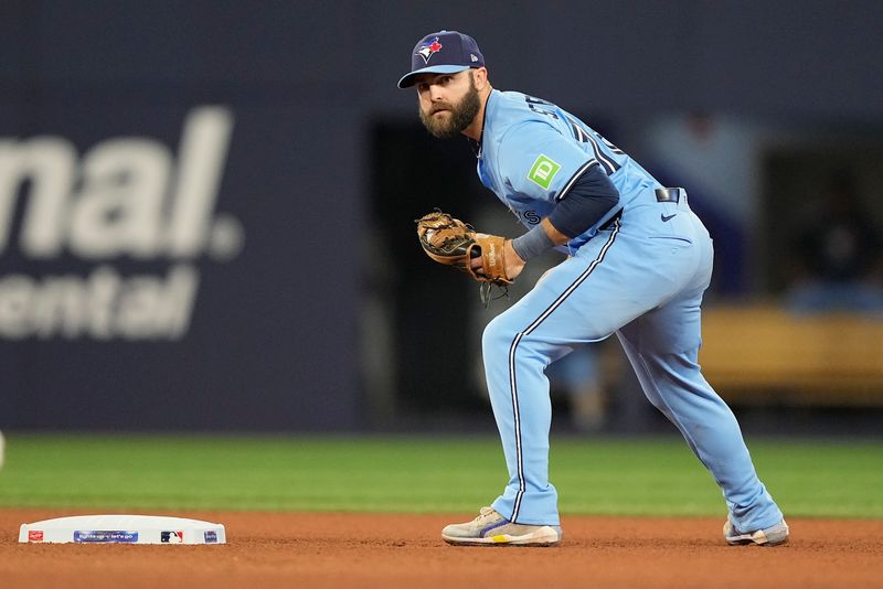 May 29, 2025; Toronto, Ontario, CAN; Toronto Blue Jays second baseman Michael Stefanic (16) holds the Athletics runner at first base during the seventh inning at Rogers Centre. Mandatory Credit: John E. Sokolowski-Imagn Images