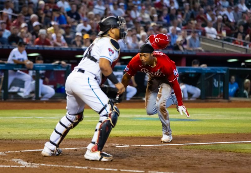 Aug 27, 2023; Phoenix, Arizona, USA; Cincinnati Reds base runner Will Benson slides into home to score a run in the sixth inning against the Arizona Diamondbacks at Chase Field. Mandatory Credit: Mark J. Rebilas-USA TODAY Sports