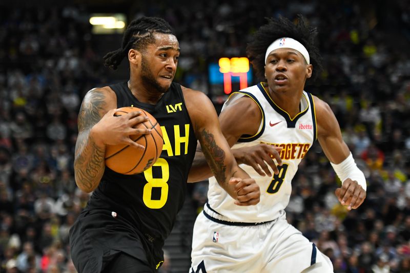 SALT LAKE CITY, UTAH - APRIL 09: Brice Sensabaugh #8 of the Utah Jazz drives against Peyton Watson #8 of the Denver Nuggets during the first half at Delta Center on April 09, 2024 in Salt Lake City, Utah. NOTE TO USER: User expressly acknowledges and agrees that, by downloading and or using this photograph, User is consenting to the terms and conditions of the Getty Images License Agreement.  (Photo by Alex Goodlett/Getty Images)