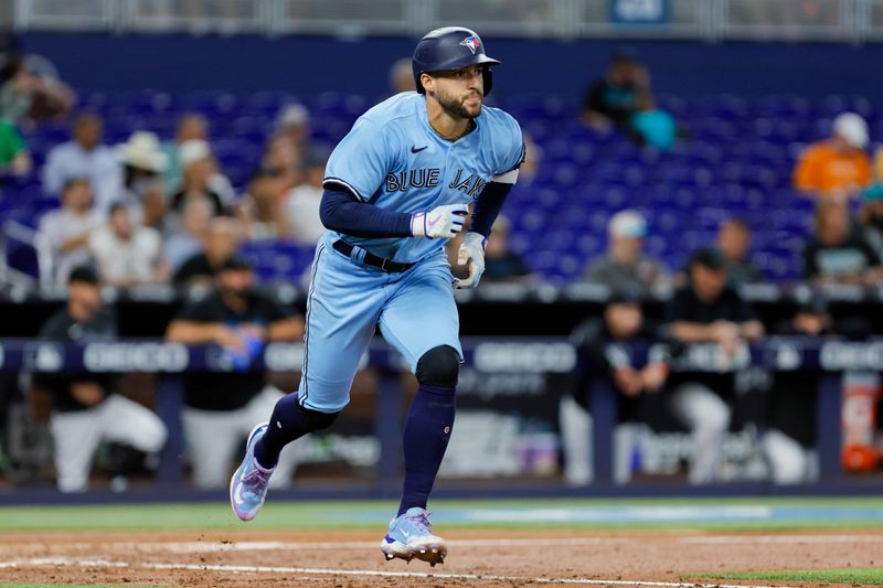 Jun 21, 2023; Miami, Florida, USA; Toronto Blue Jays right fielder George Springer (4) runs toward first base after hitting a single against the Miami Marlins during the fourth inning at loanDepot Park. Mandatory Credit: Sam Navarro-USA TODAY Sports