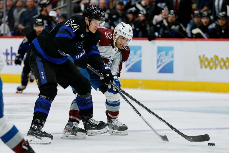 Feb 24, 2024; Denver, Colorado, USA; Toronto Maple Leafs center David Kampf (64) and Colorado Avalanche center Andrew Cogliano (11) battle for the puck in the first period at Ball Arena. Mandatory Credit: Isaiah J. Downing-USA TODAY Sports