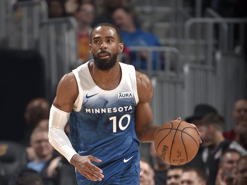 CLEVELAND, OH - MARCH 8: Mike Conley #10 of the Minnesota Timberwolves dribbles the ball during the game against the Cleveland Cavaliers on March 8, 2024 at Rocket Mortgage FieldHouse in Cleveland, Ohio. NOTE TO USER: User expressly acknowledges and agrees that, by downloading and/or using this Photograph, user is consenting to the terms and conditions of the Getty Images License Agreement. Mandatory Copyright Notice: Copyright 2024 NBAE (Photo by David Liam Kyle/NBAE via Getty Images)