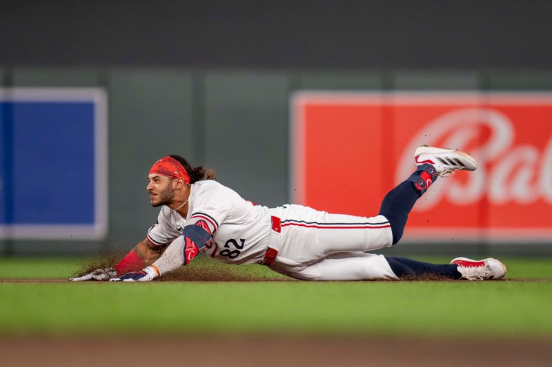 Sep 9, 2024; Minneapolis, Minnesota, USA; Minnesota Twins left fielder Austin Martin (82) slides into second base for a double during the fourth inning against the Los Angeles Angels at Target Field. Mandatory Credit: Jesse Johnson-Imagn Images