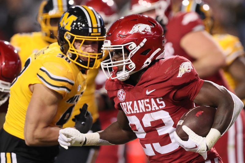 Nov 24, 2023; Fayetteville, Arkansas, USA; Arkansas Razorbacks running back Isaiah Augustave (23) rushes in the second half against the Missouri Tigers at Donald W. Reynolds Razorback Stadium. Missouri won 48-14. Mandatory Credit: Nelson Chenault-USA TODAY Sports