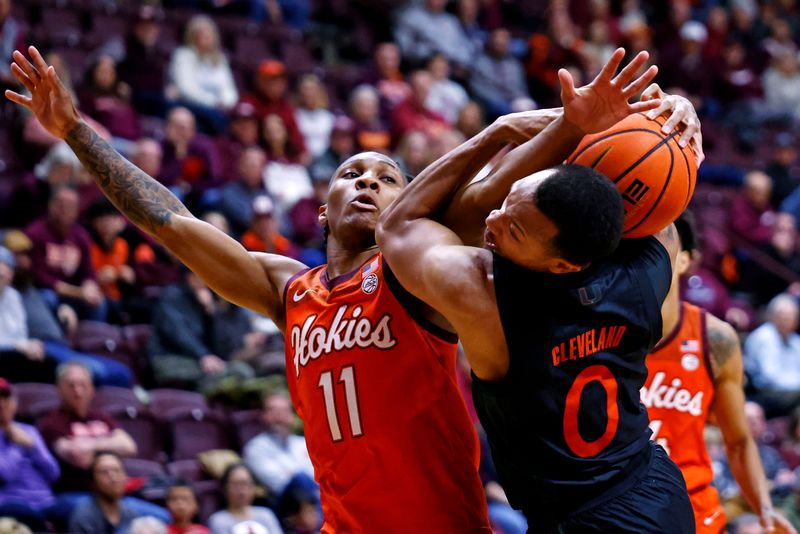 Jan 4, 2025; Blacksburg, Virginia, USA; Virginia Tech Hokies guard Ben Hammond (11) and Miami Hurricanes guard Matthew Cleveland (0) go for the ball during the second half at Cassell Coliseum. Mandatory Credit: Peter Casey-Imagn Images