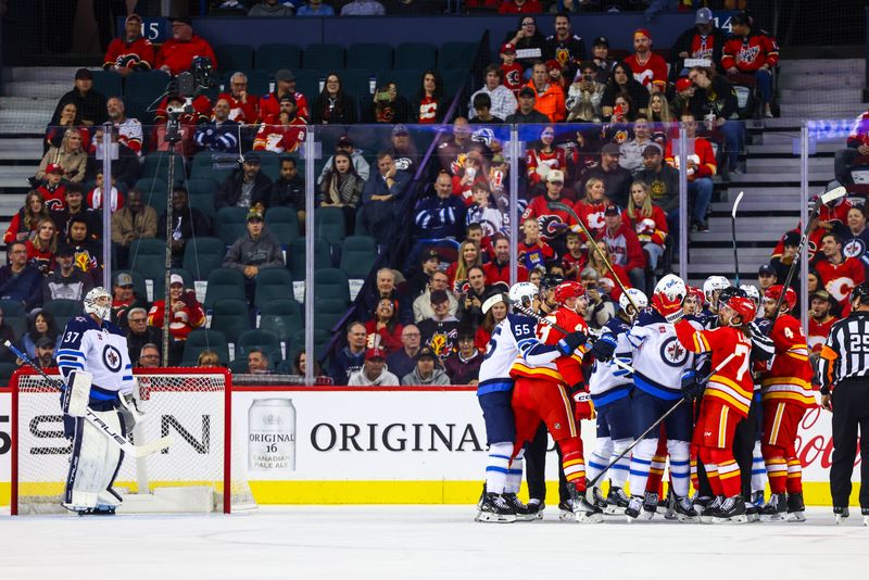 Oct 4, 2024; Calgary, Alberta, CAN; Calgary Flames right wing Adam Klapka (43) and Winnipeg Jets defenseman Haydn Fleury (24) gets into a scrum during the first period at Scotiabank Saddledome. Mandatory Credit: Sergei Belski-Imagn Images