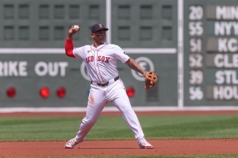 Jun 5, 2024; Boston, Massachusetts, USA; Boston Red Sox third baseman Rafael Devers (11) throws to first during the first inning against the Atlanta Braves at Fenway Park. Mandatory Credit: Paul Rutherford-USA TODAY Sports