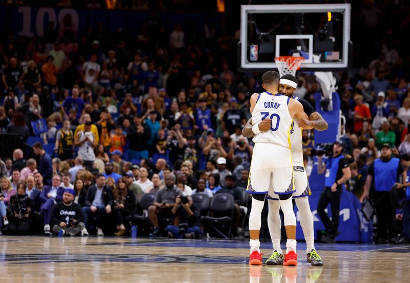 ORLANDO, FLORIDA - MARCH 27: Stephen Curry #30 and Gary Payton II #0 of the Golden State Warriors reacts to winning a game against the Orlando Magic at Kia Center on March 27, 2024 in Orlando, Florida. NOTE TO USER: User expressly acknowledges and agrees that, by downloading and or using this photograph, User is consenting to the terms and conditions of the Getty Images License Agreement. (Photo by Mike Ehrmann/Getty Images)