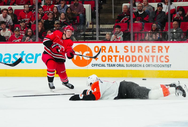 Mar 21, 2024; Raleigh, North Carolina, USA; Carolina Hurricanes right wing Andrei Svechnikov (37) gets the shot past Philadelphia Flyers defenseman Travis Sanheim (6) during the third period at PNC Arena. Mandatory Credit: James Guillory-USA TODAY Sports