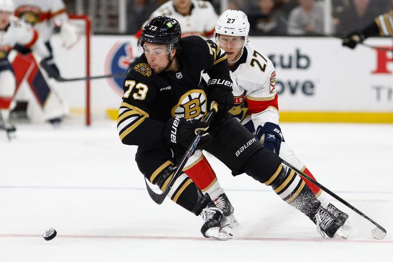 May 10, 2024; Boston, Massachusetts, USA; Boston Bruins defenseman Charlie McAvoy (73) cuts away from Florida Panthers center Eetu Luostarinen (27) during the third period of game three of the second round of the 2024 Stanley Cup Playoffs at TD Garden. Mandatory Credit: Winslow Townson-USA TODAY Sports