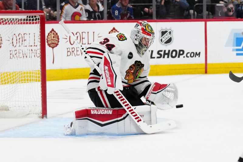 Mar 4, 2024; Denver, Colorado, USA; Chicago Blackhawks goaltender Petr Mrazek (34) makes a save in the second period against the Colorado Avalanche at Ball Arena. Mandatory Credit: Ron Chenoy-USA TODAY Sports