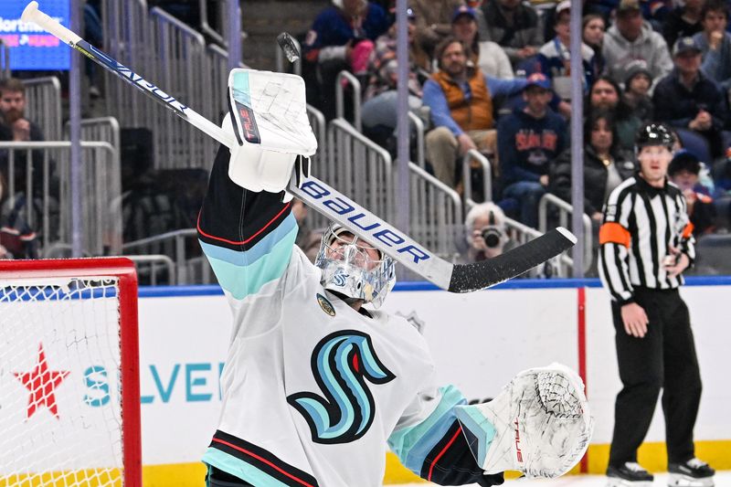 Feb 13, 2024; Elmont, New York, USA; Seattle Kraken goaltender Philipp Grubauer (31) makes a blocker save against the New York Islanders during the second period at UBS Arena. Mandatory Credit: Dennis Schneidler-USA TODAY Sports