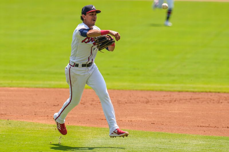 Aug 20, 2023; Cumberland, Georgia, USA; Atlanta Braves second baseman Nicky Lopez (15) throws out a San Francisco Giants batter after fielding a ground ball during the first inning at Truist Park. Mandatory Credit: Dale Zanine-USA TODAY Sports