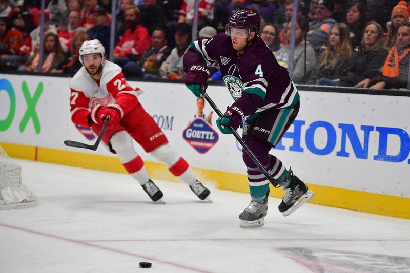 Jan 7, 2024; Anaheim, California, USA; Anaheim Ducks defenseman Cam Fowler (4) moves the puck against Detroit Red Wings center Michael Rasmussen (27) during the first period at Honda Center. Mandatory Credit: Gary A. Vasquez-USA TODAY Sports